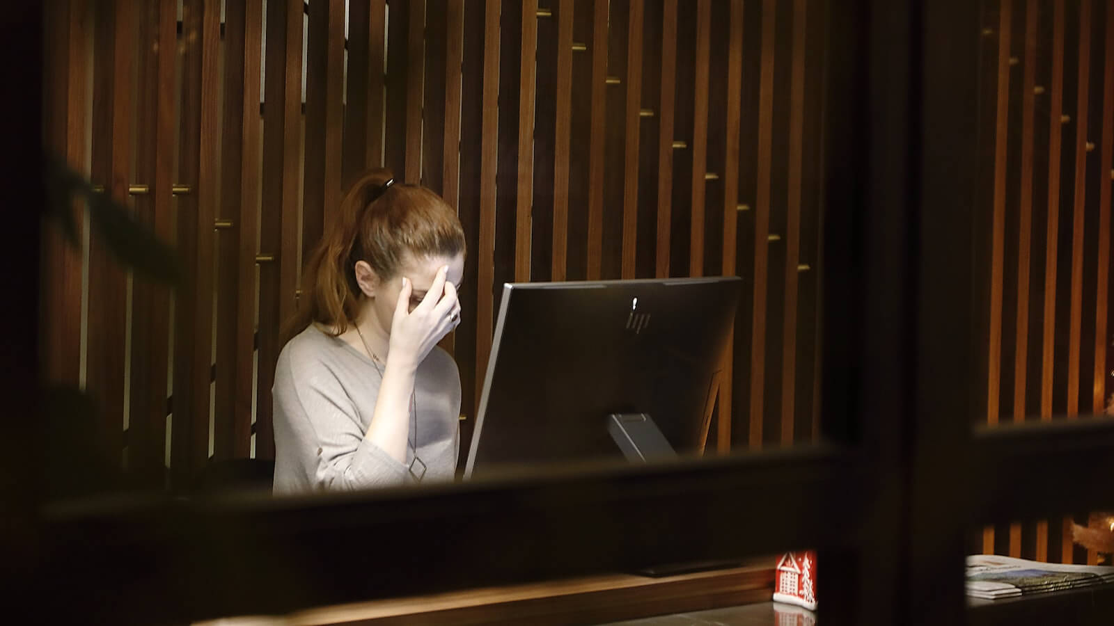 Person at desk verifying crypto platform legitimacy on laptop screen with regulatory checklist